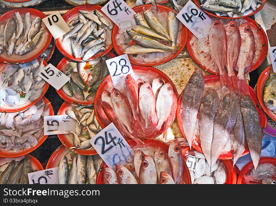 Whole fresh fishes are offered in the fish market in asia