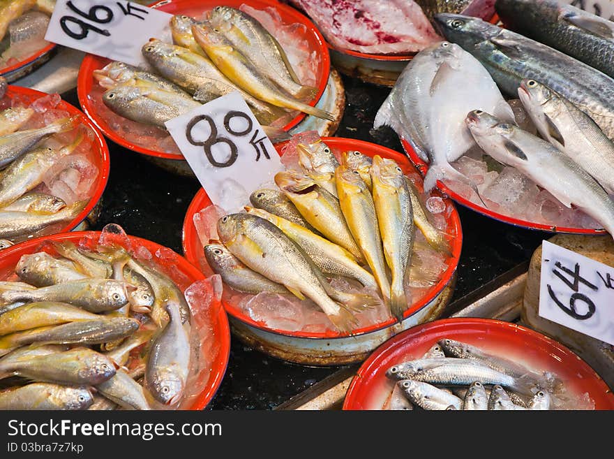 Whole fresh fishes are offered in the fish market in asia