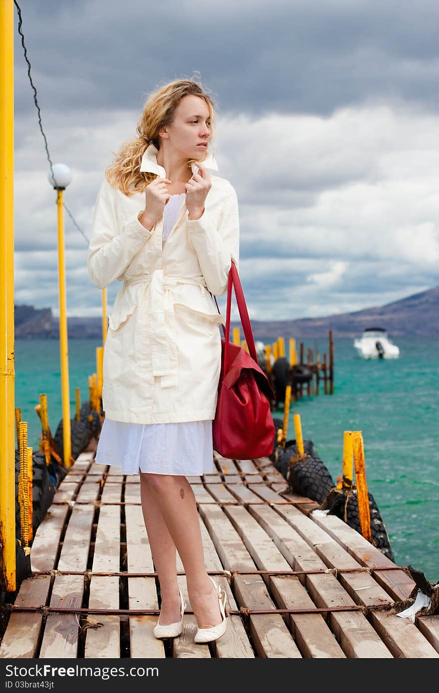 Woman in white walking on footbridge