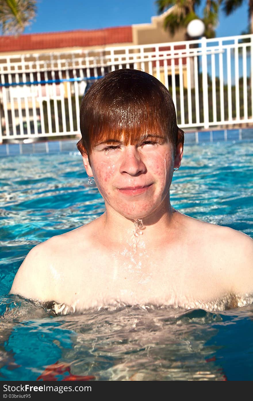 Happy child is swimming in the pool