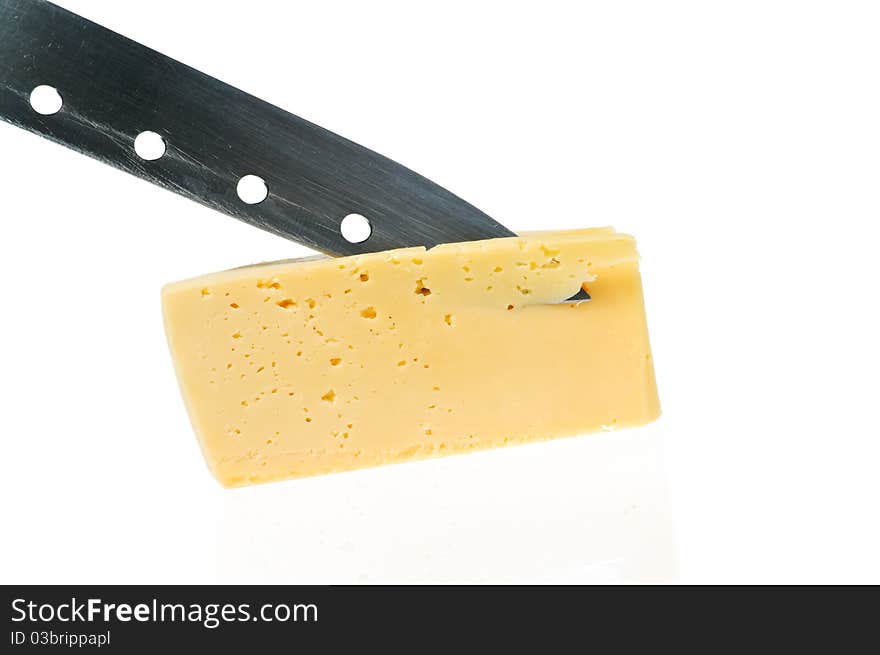 Cheese piece with knife is reflected in a white. Cheese piece with knife is reflected in a white