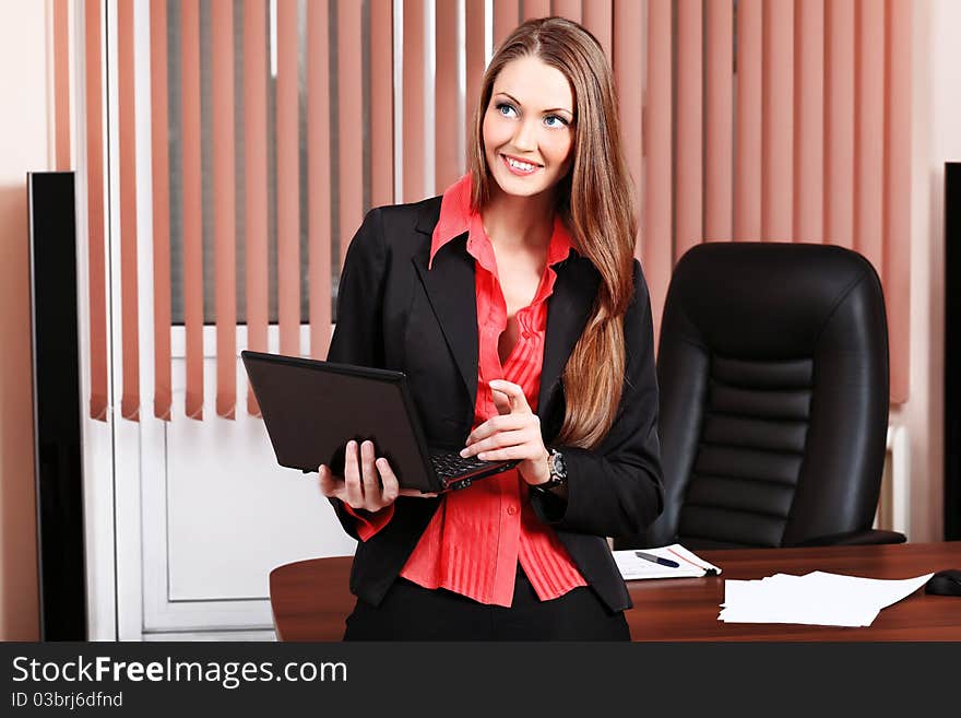 Beautiful business woman is working at the office. Beautiful business woman is working at the office.