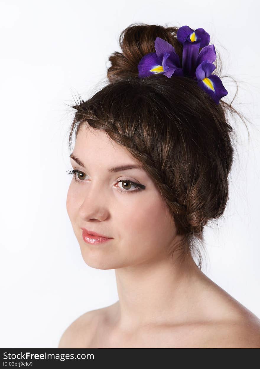 Portrait of the beauty young brunette girl with iris in her hair