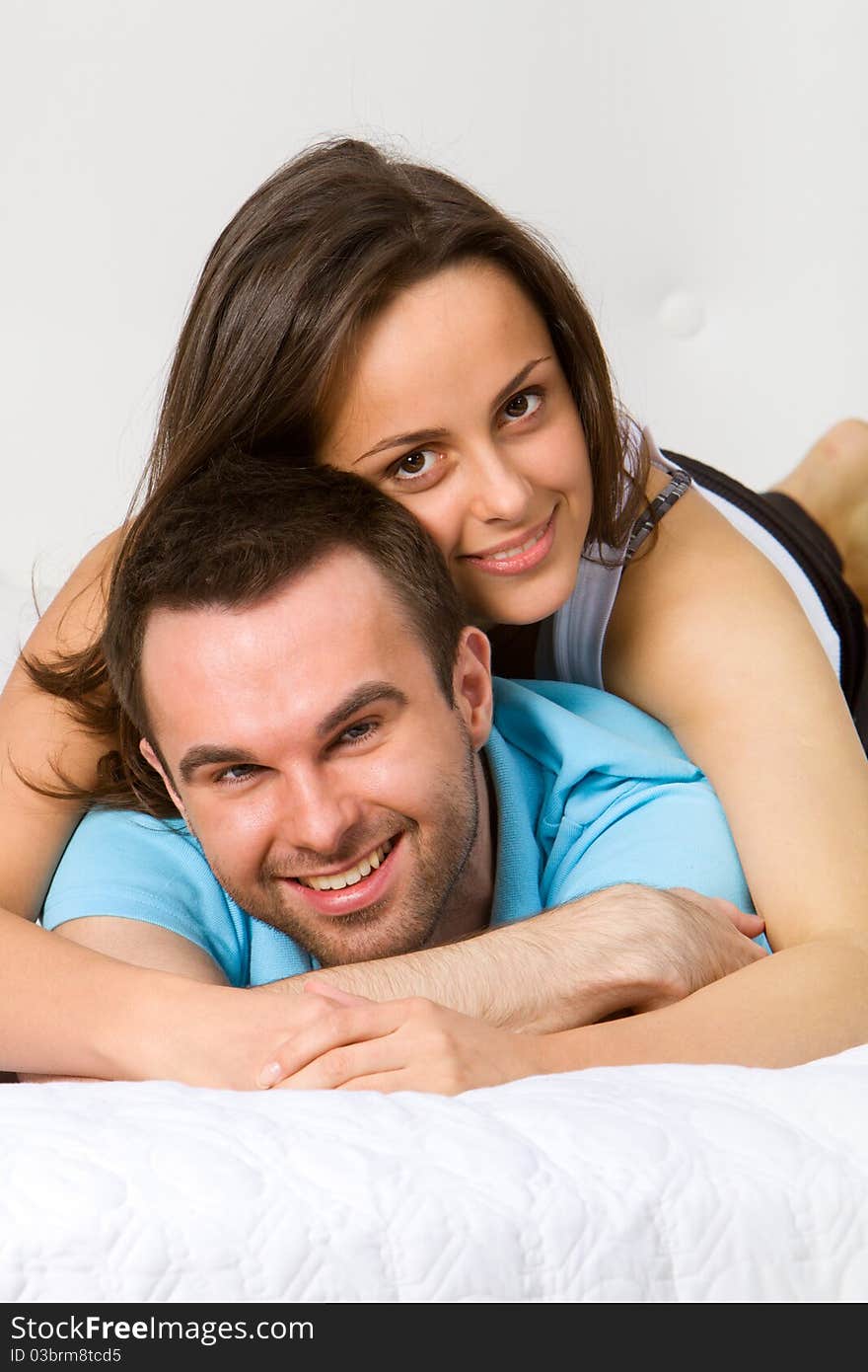 Young couple embracing in bedroom