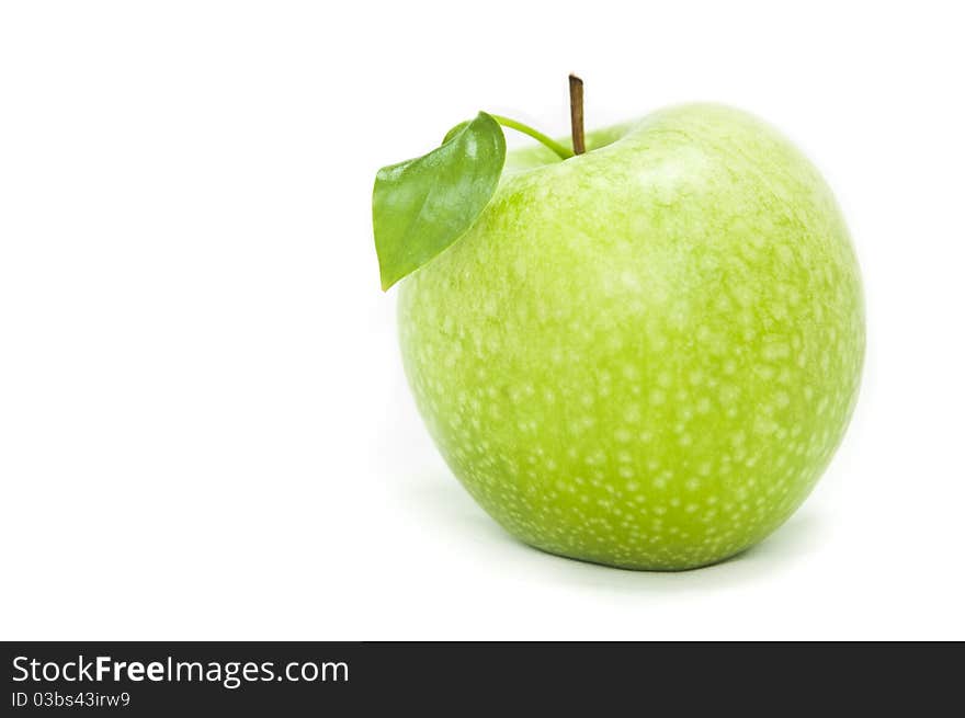 Green apple in a speck on a white background