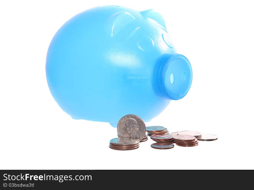 Piggy bank and coins isolated over the white background. Piggy bank and coins isolated over the white background