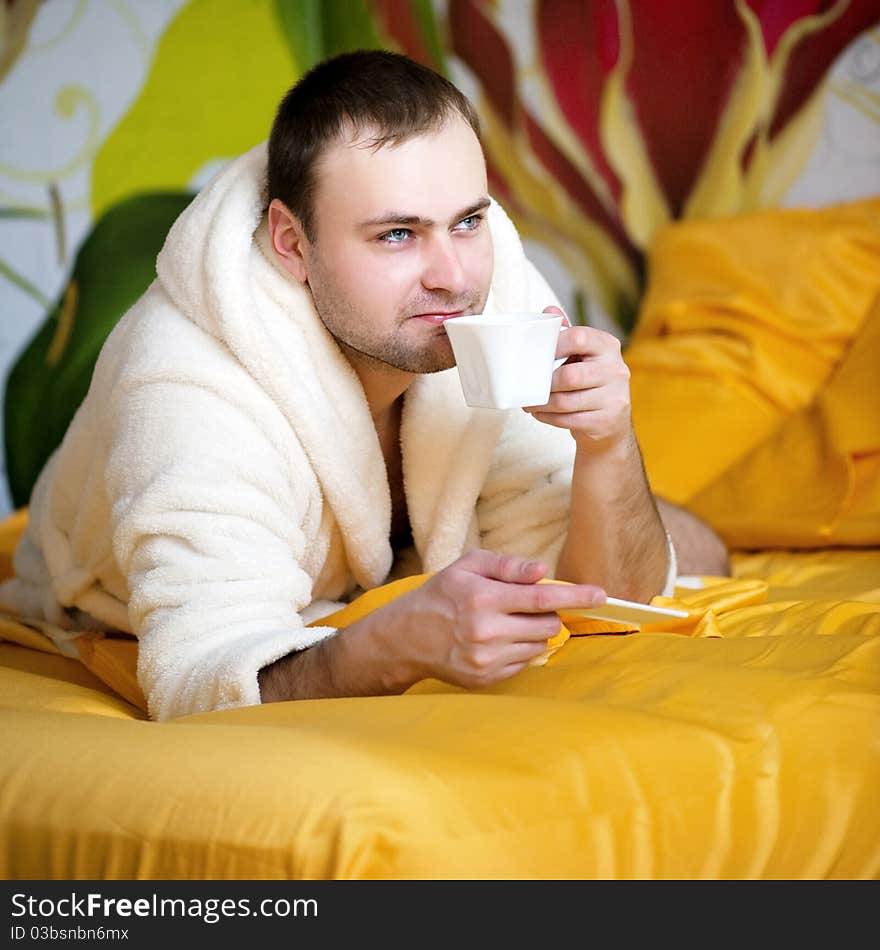 Handsome man lying in bed