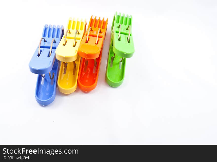 Colorful clothes pegs on white background