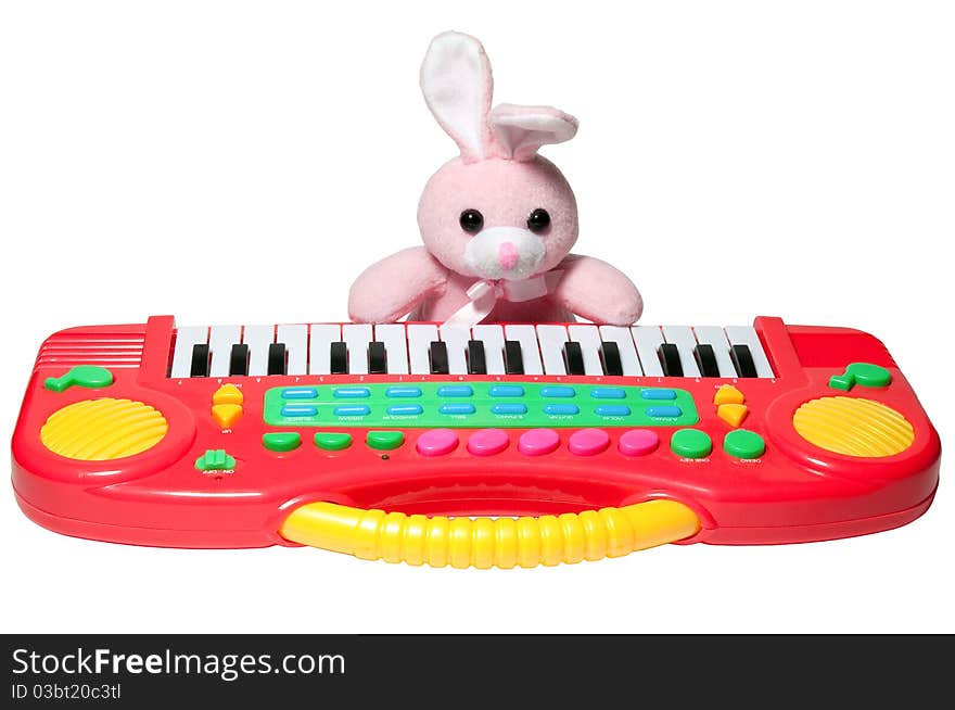 Isolated pink rabbit with a bent ear, and synthesizer. Isolated pink rabbit with a bent ear, and synthesizer