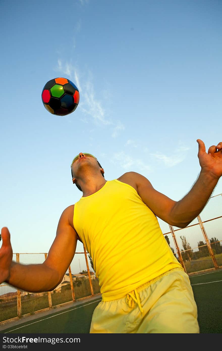 Football player shooting a ball with his head