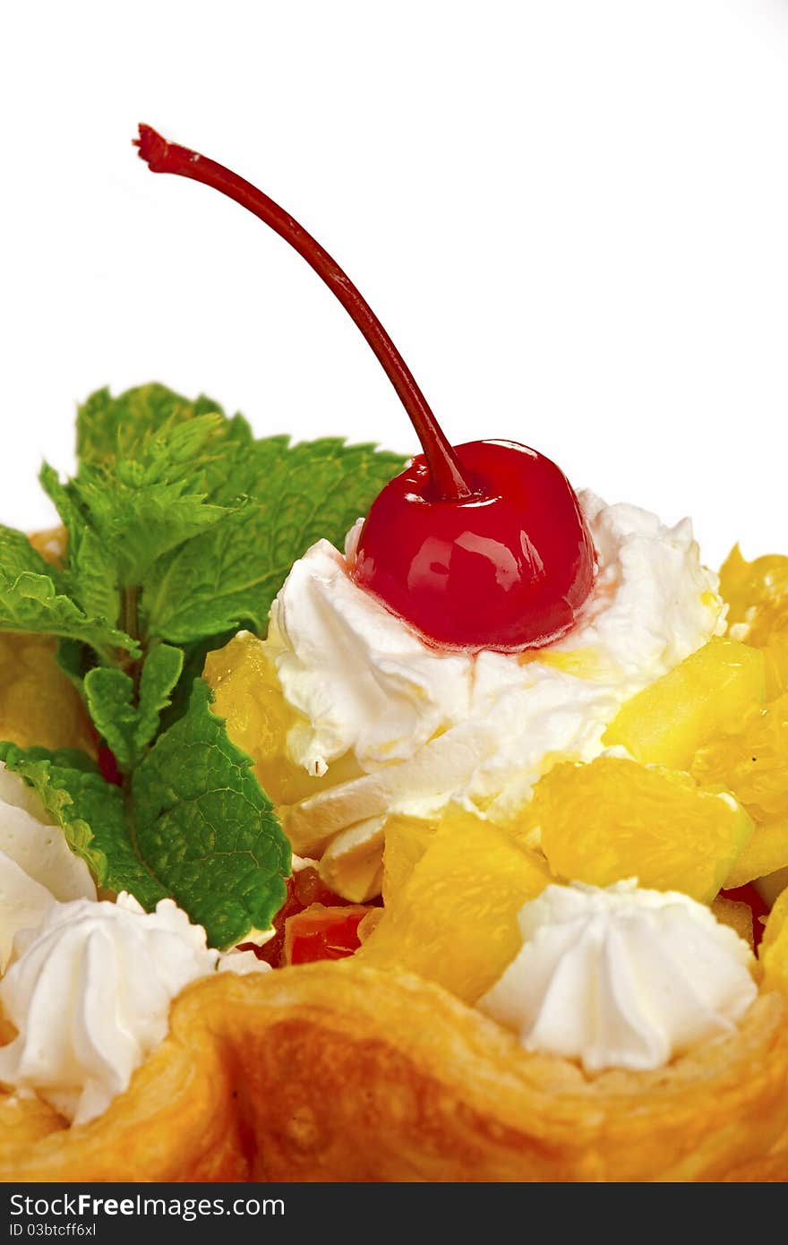 Closeup of fresh baked home made basket cake and maraschino cherry on top isolated on white. Closeup of fresh baked home made basket cake and maraschino cherry on top isolated on white