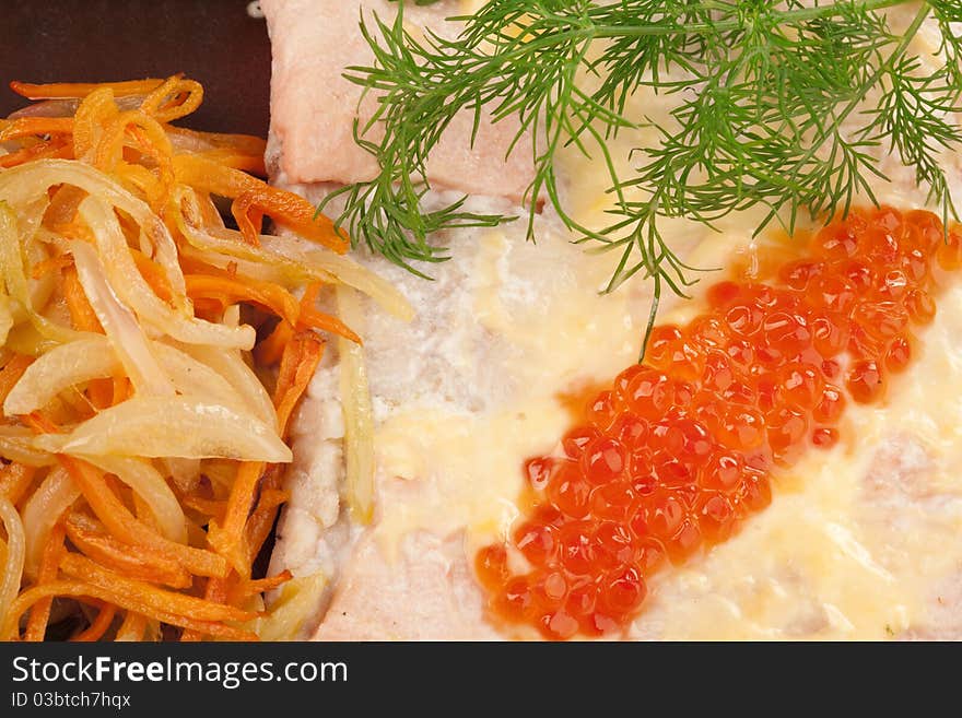 Broiled salmon steak with cream souse and red caviar decorated with dill, lemon and fried onion with carrot, isolated on white. Broiled salmon steak with cream souse and red caviar decorated with dill, lemon and fried onion with carrot, isolated on white