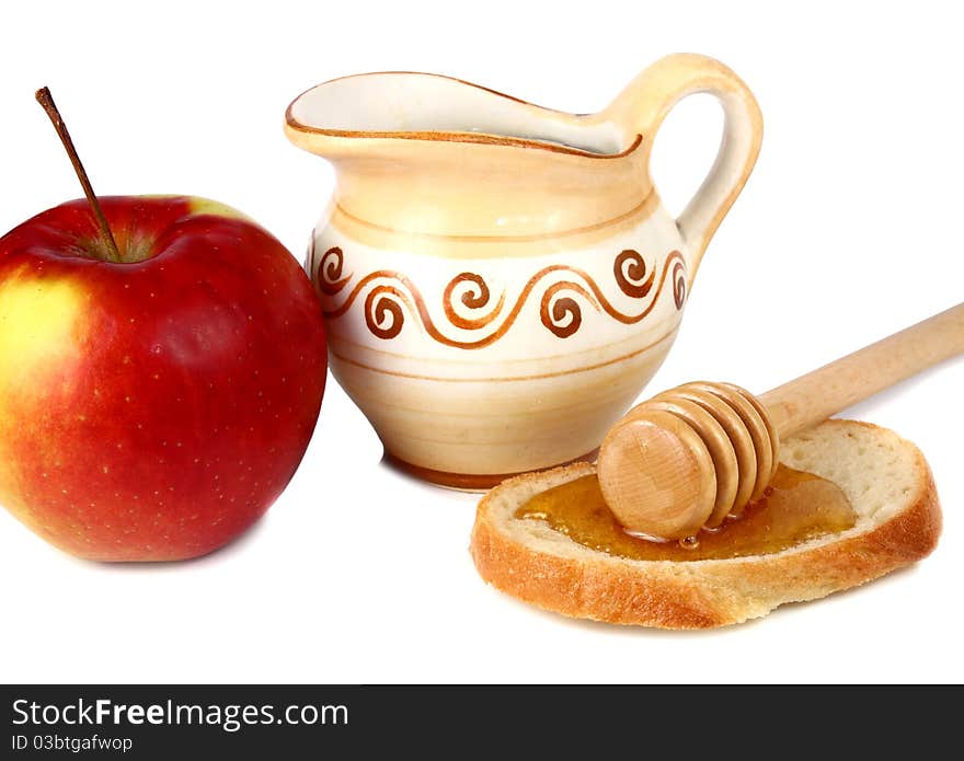 Honey in a jug and apple isolated on white background