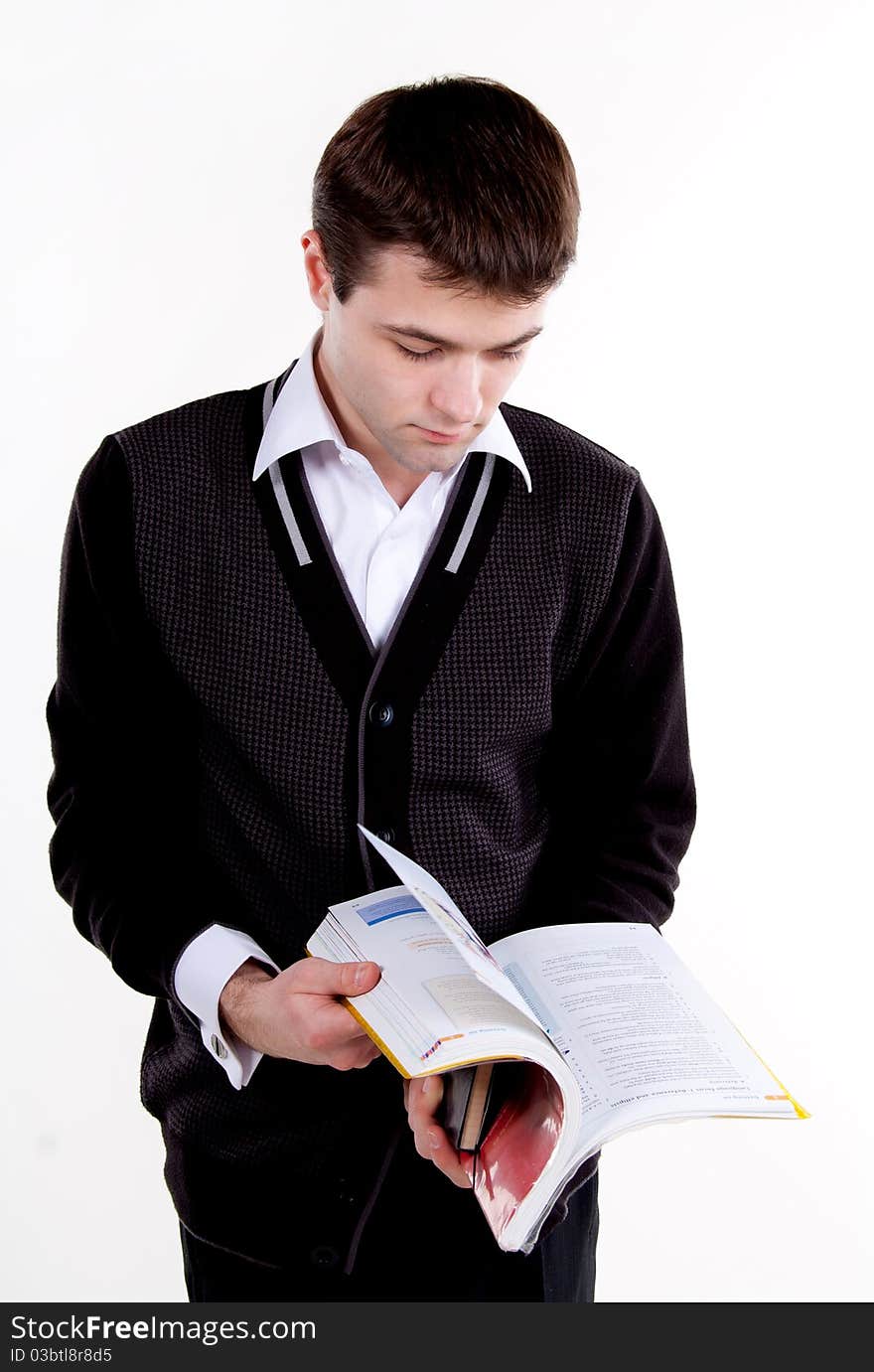 A university college student or casual man reading or studying a textbook.