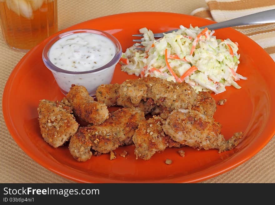 Chicken strip meal with dipping sauce and coleslaw