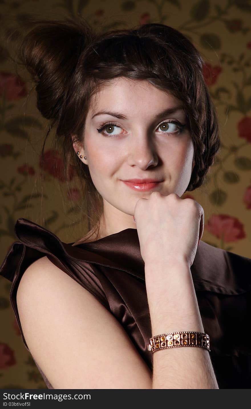 Portrait of the beautiful stylish brunette woman in brown dress