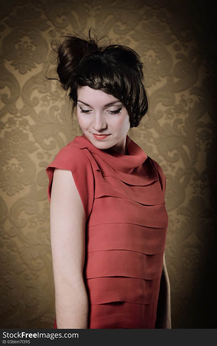 Portrait of the beautiful stylish brunette woman in red