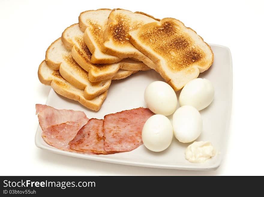 Breakfast. Toasts, eggs, bacon on white background