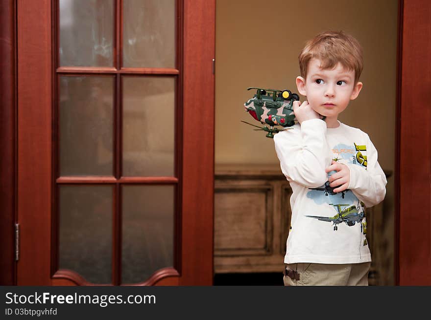 Little boy playing with toy helicopter at home. Little boy playing with toy helicopter at home