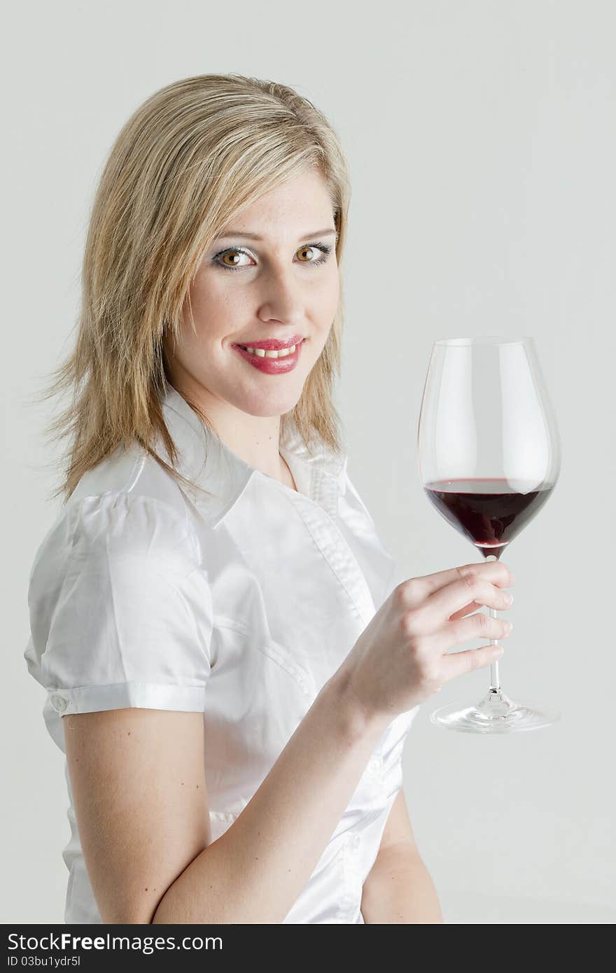 Portrait of young woman with a glass of red wine