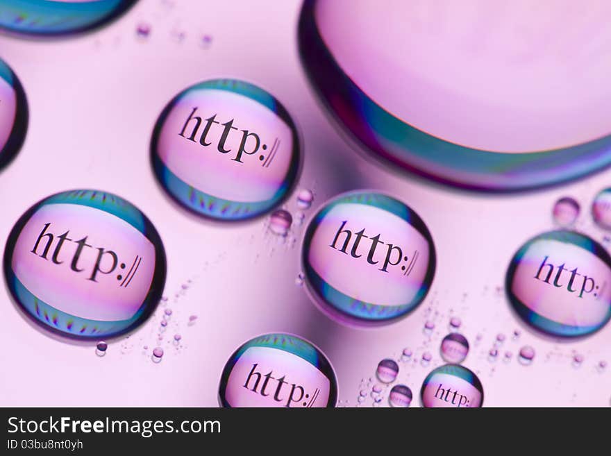 The words http:// reflected in the drops of water. Close-up of water droplets placed on a DVD disc. The words http:// reflected in the drops of water. Close-up of water droplets placed on a DVD disc.