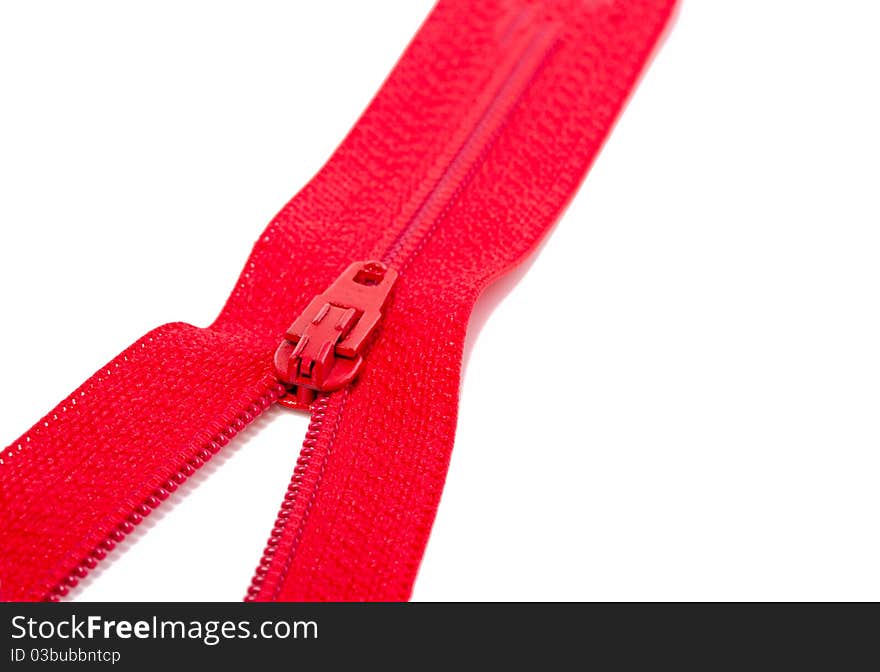 A close up of a red zipper isolated over white