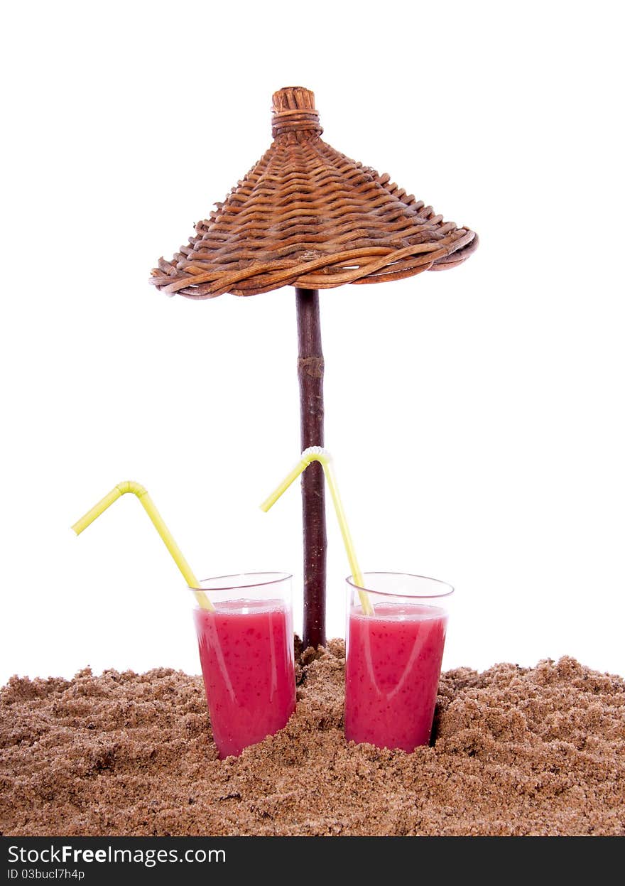 Two fresh summer fruit cocktails under a beach parasol isolated over white. Two fresh summer fruit cocktails under a beach parasol isolated over white