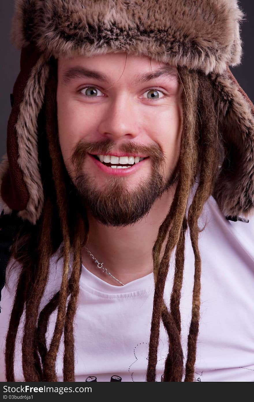 Guy with dreadlocks wearing a fur hat