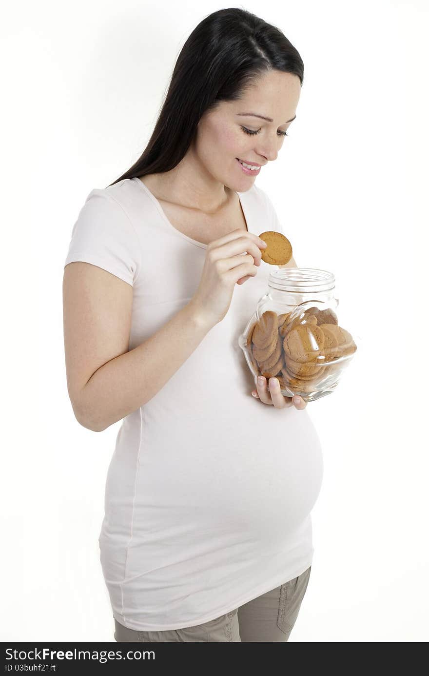 Pregnant woman looking in cookie jar isolated on white. Pregnant woman looking in cookie jar isolated on white