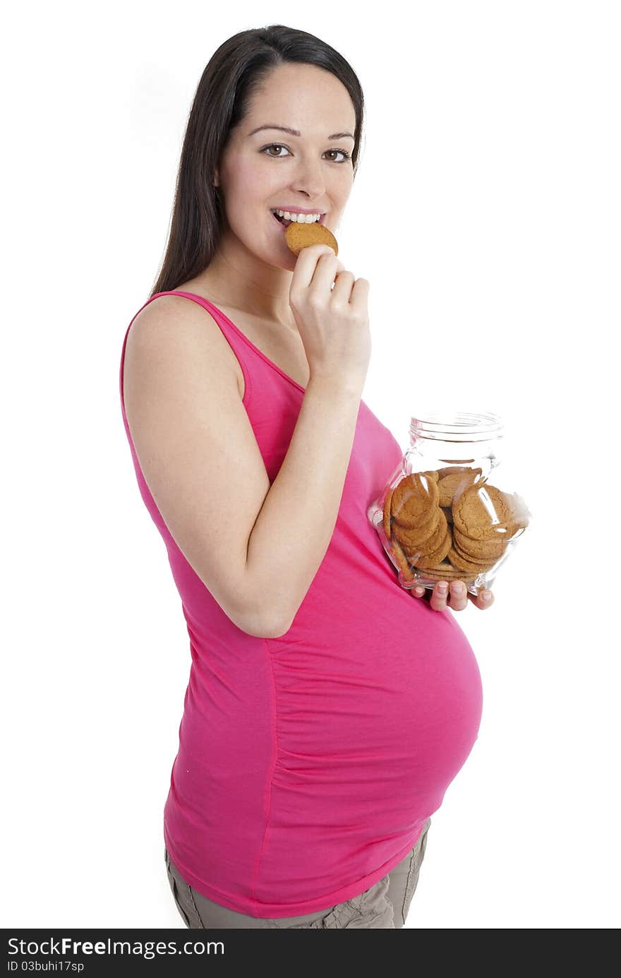 Pregnant woman looking to camera enjoying a biscuit. Pregnant woman looking to camera enjoying a biscuit