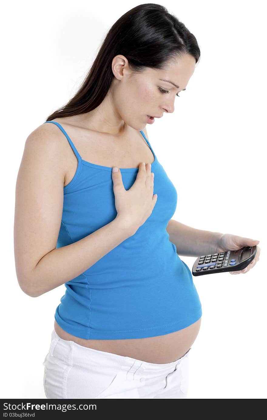 Pregnant woman looking shocked at calculator. Pregnant woman looking shocked at calculator