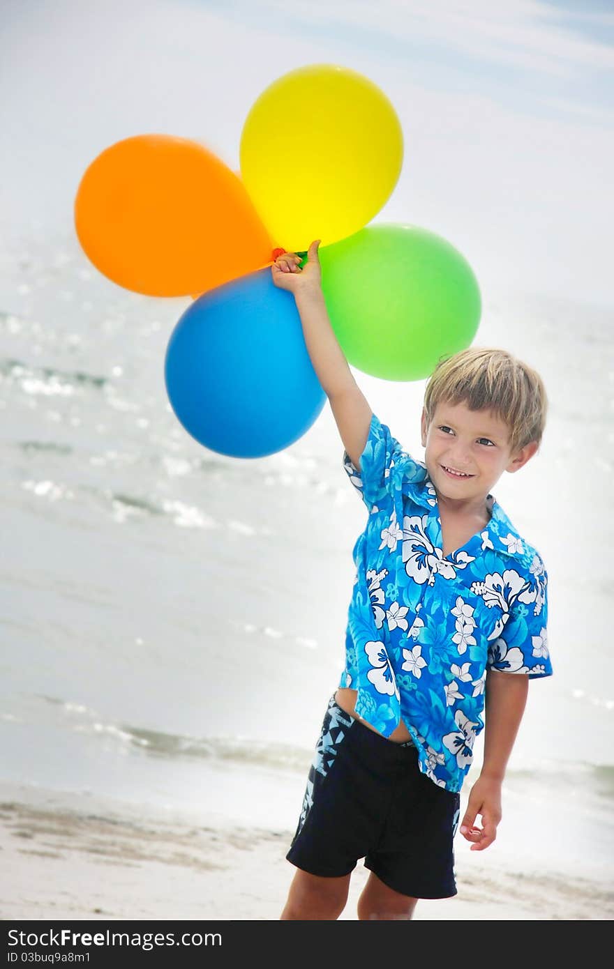 Young happy boy running with balloons