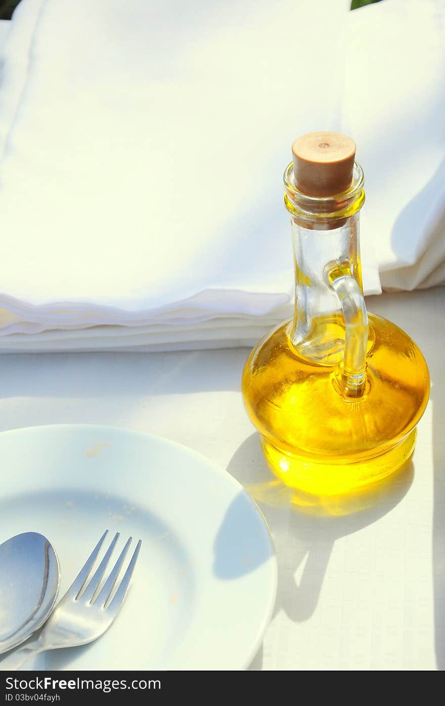 An olive oil bottle on table