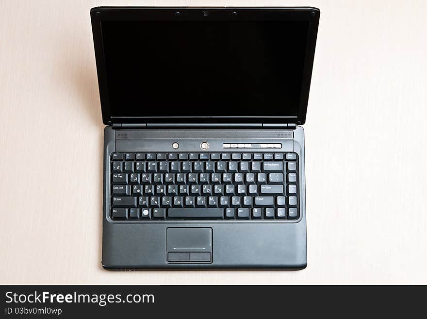 Black laptop on an office wood desk. Black laptop on an office wood desk