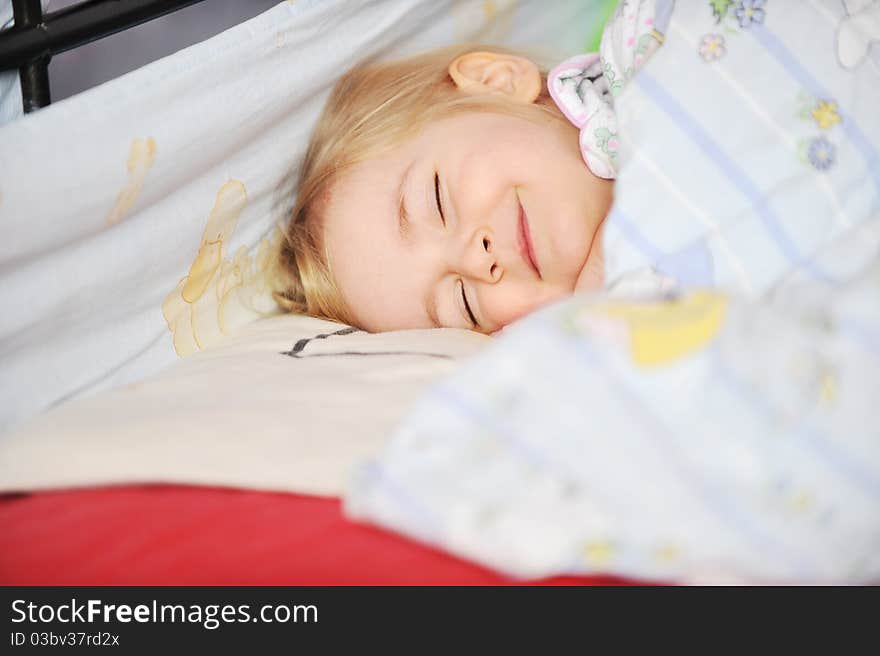 Cute little girl sleeping in bed