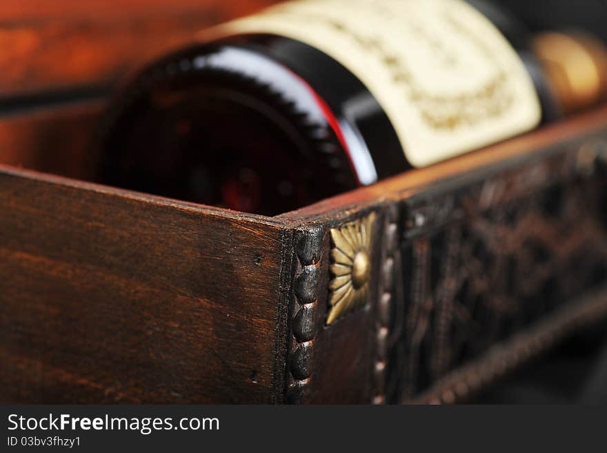 Cognac bottle in wooden case background