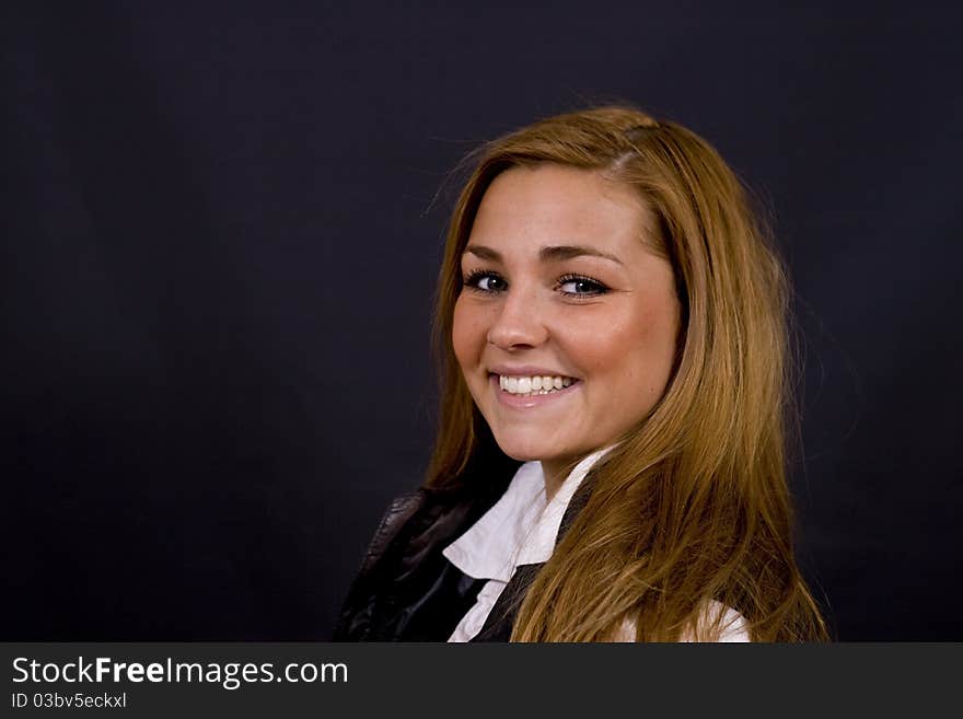 Young danish scandinavian woman with beautiful long brown hair and green/grey eyes, on black studio background. Young danish scandinavian woman with beautiful long brown hair and green/grey eyes, on black studio background.