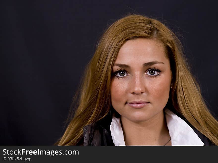 Young danish scandinavian woman with beautiful long brown hair and green/grey eyes, on black studio background. Young danish scandinavian woman with beautiful long brown hair and green/grey eyes, on black studio background.