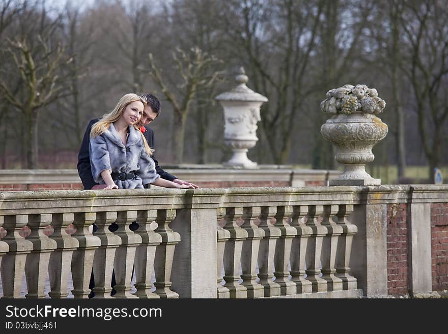 Young happy couple embracing on the bridge. Young happy couple embracing on the bridge