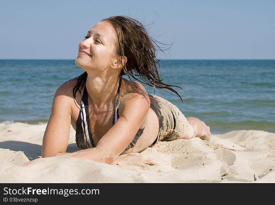 Young woman lying on a beach. Young woman lying on a beach