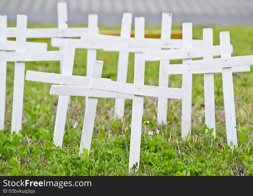 Crosses lined up on the side of the road.