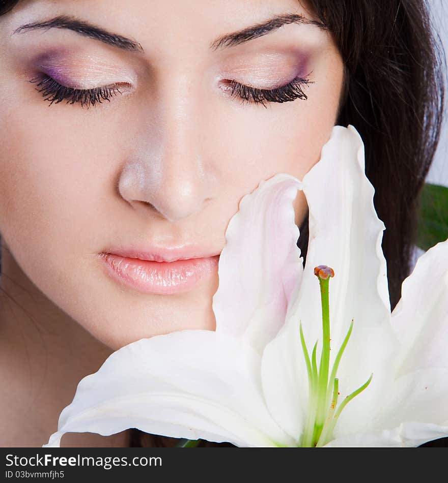 Beautiful young woman with fresh clean skin and white flower. Beautiful young woman with fresh clean skin and white flower