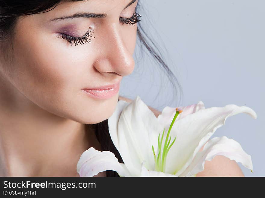 Beautiful young woman with fresh clean skin and white flower. Beautiful young woman with fresh clean skin and white flower