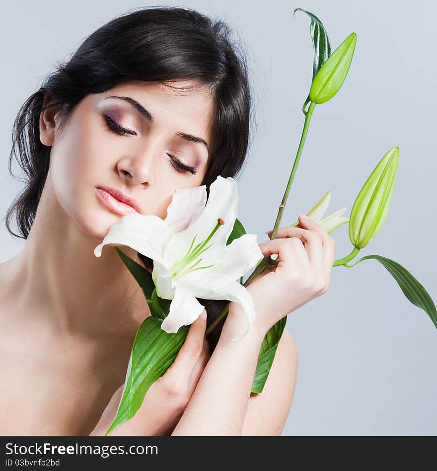 Beautiful young woman with fresh clean skin and white flower. Beautiful young woman with fresh clean skin and white flower