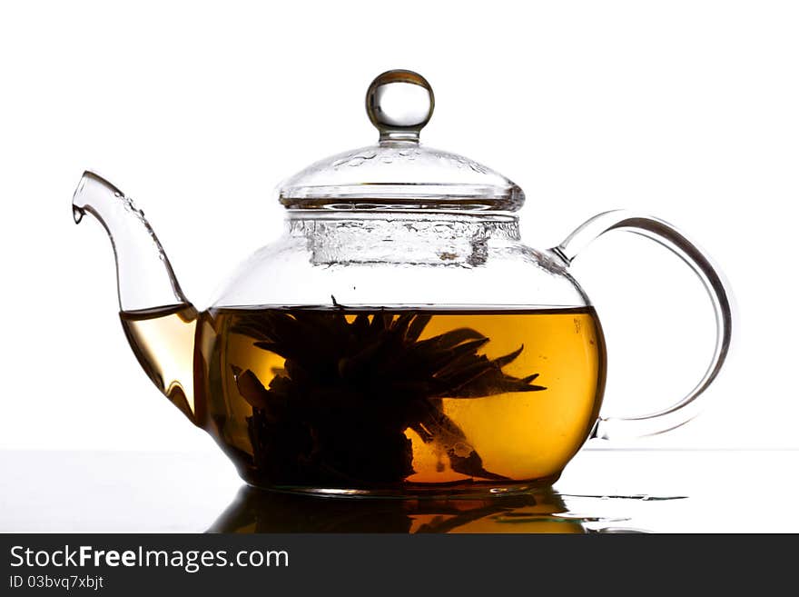 Tea in glass pot isolated