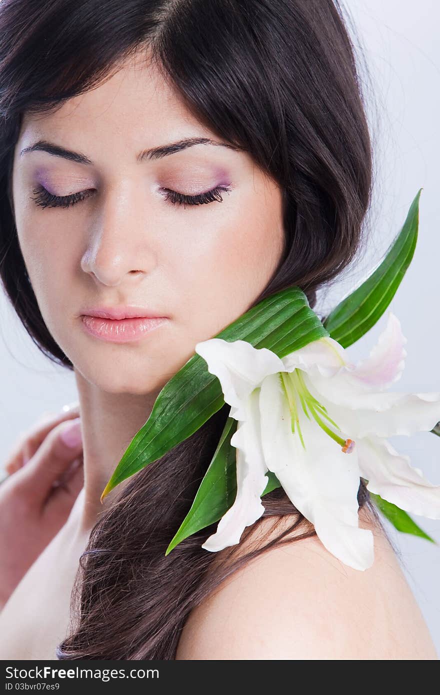 Beautiful young woman with fresh clean skin and white flower. Beautiful young woman with fresh clean skin and white flower