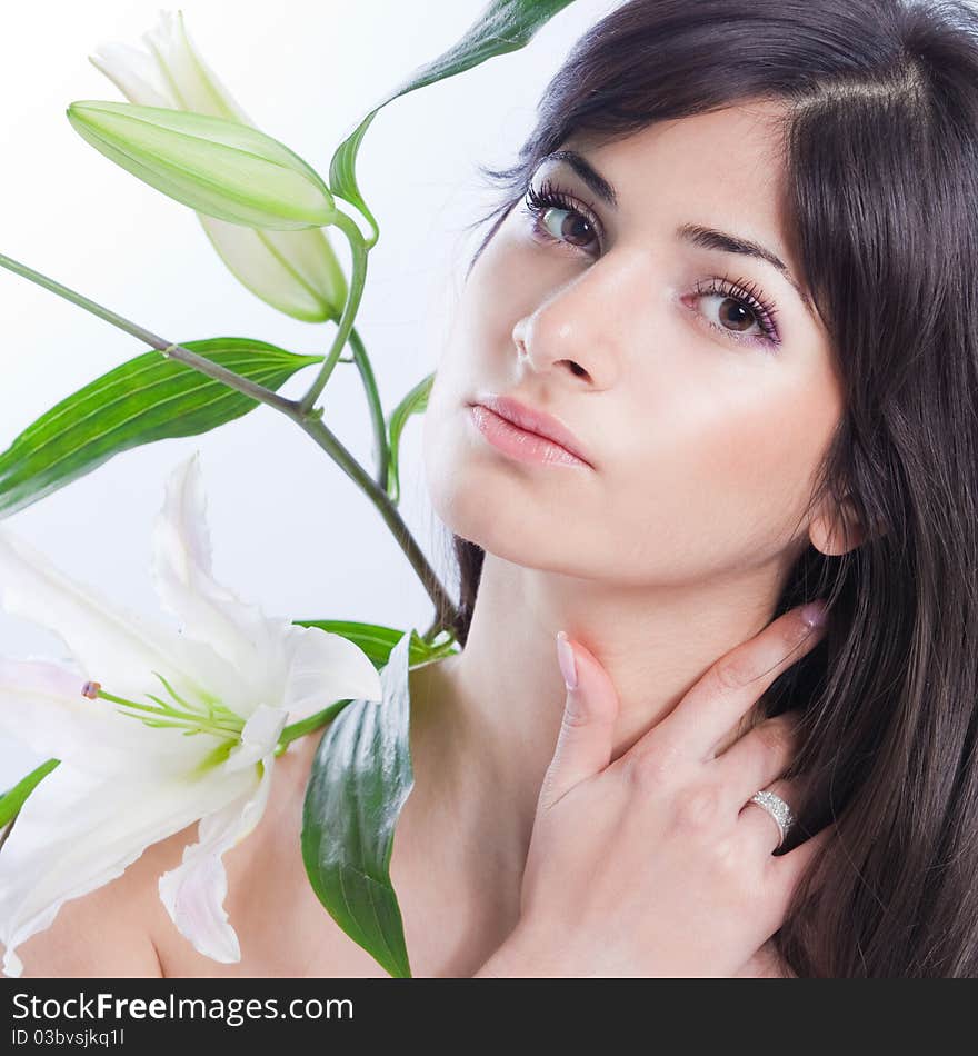 Beautiful young woman with fresh clean skin and white flower. Beautiful young woman with fresh clean skin and white flower