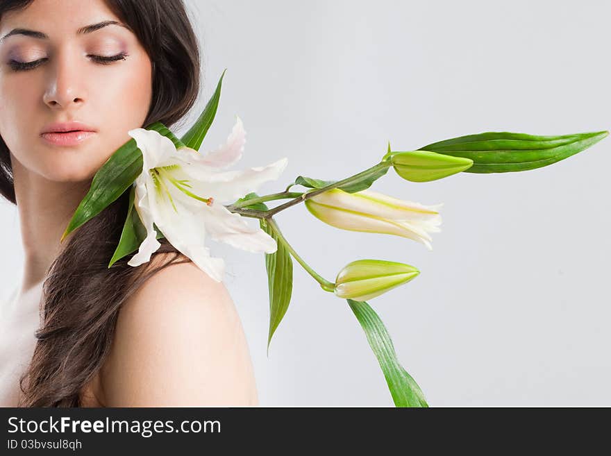 Beautiful young woman with fresh clean skin and white flower. Beautiful young woman with fresh clean skin and white flower