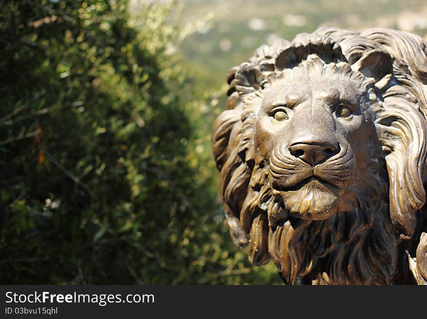 Lion statue in park park on background