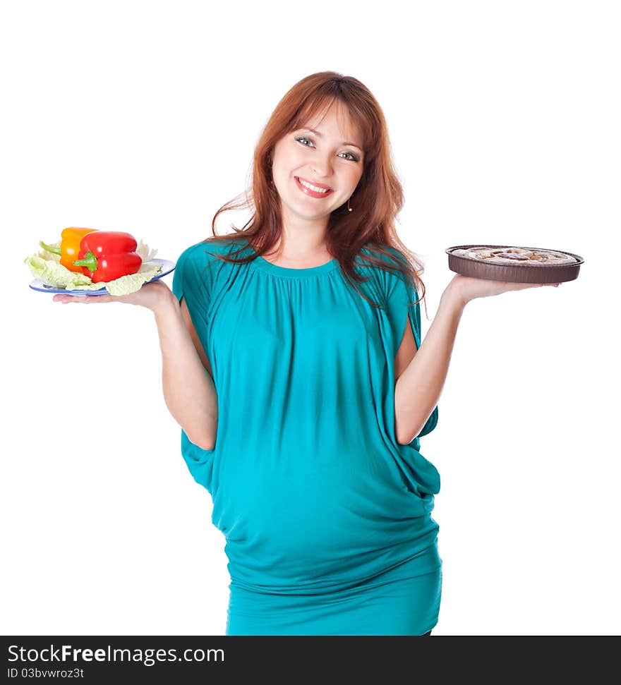 A pregnant smiling young woman is holding food in her hands. Isolated on a white background. A pregnant smiling young woman is holding food in her hands. Isolated on a white background